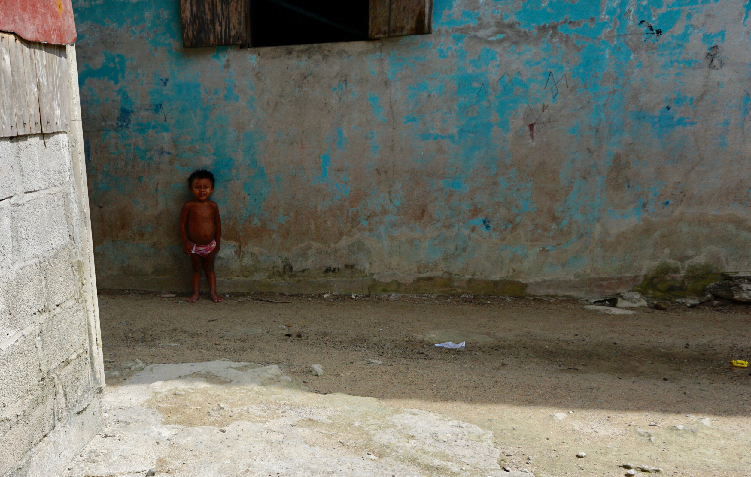 76. Young boy outside his home
