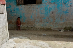 76. Young boy outside his home