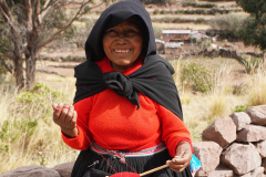 51.-Local-woman-dressed-in-traditional-garb-walking-while-spinning-her-alpaca-wool.